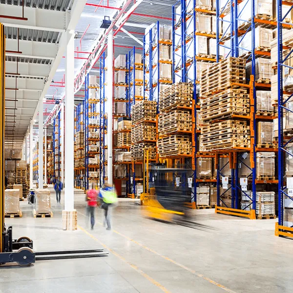 Forklifts and people in warehouse 